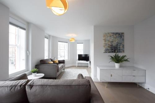 a living room with a couch and a table at Modern,Bright and spacious 2 bed in Brentwood