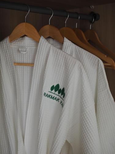 a group of white shirts hanging on a rack at Rakmak Kan Resort & Cafe in Ban Wang Dong