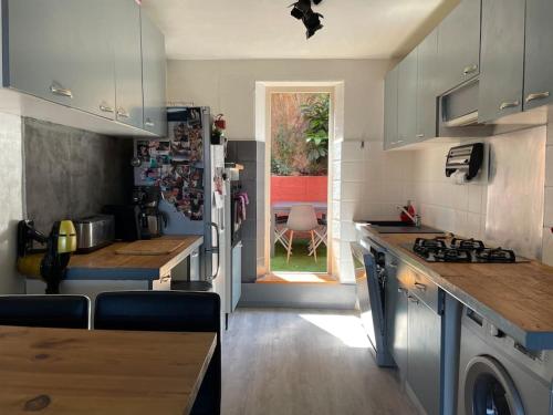 a kitchen with a stove and a counter top at Cosy House Collioure in Collioure