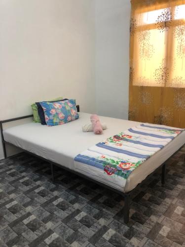 a bed sitting in a room with at Homestay Idaman B B with 2 room aircond 2 Quen Bed and Not Sharing Room -Privacy in Kuala Terengganu