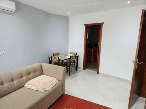 a living room with a couch and a table at E2G Meublé 1 CH 2e CH dispo avec supplément in Douala