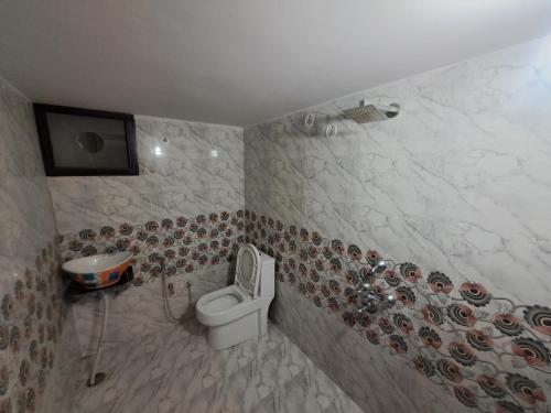 a bathroom with a toilet and a sink at Swaraj Palace in Jaipur