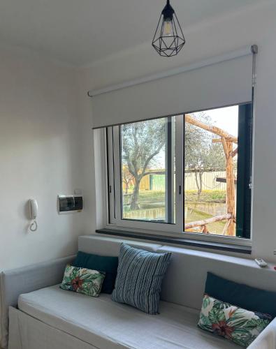 a window in a room with a couch with pillows at cerasella house in Castellammare di Stabia