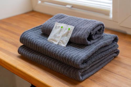 a pile of towels sitting on a table at Baltic Design Apartments with free Parking in Rīga