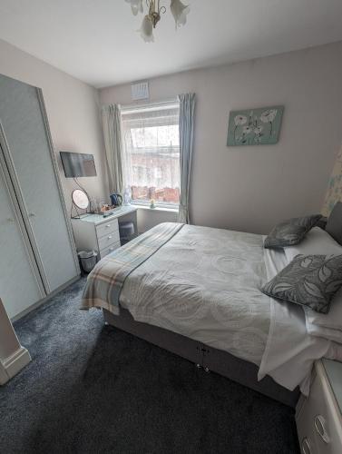 a bedroom with a large bed and a window at Hesketh Hotel in Blackpool