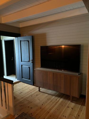 a living room with a large flat screen television at Ladegaarden in Skien