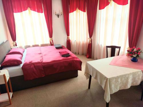 a bedroom with two beds and red curtains at Gasthof Oberschmiede in Auf der Wiese