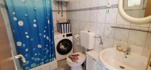 a small bathroom with a toilet and a sink at Bungalow Tribunj in Tribunj
