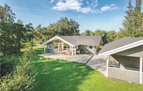 a house with a large deck next to a yard at Holiday Home Spovevej Gørlev Xii in Gørlev