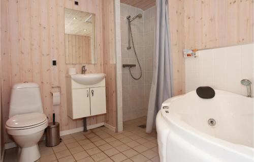 a bathroom with a toilet and a sink and a tub at Holiday Home Spovevej Gørlev Xii in Gørlev
