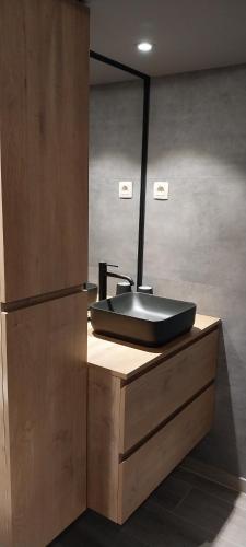 a bathroom with a black sink on a counter at Al Copette in Durbuy