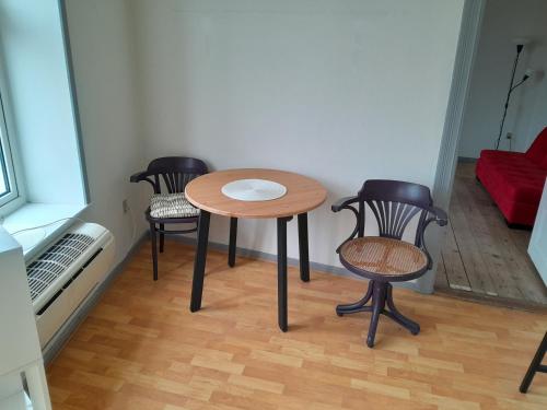 une petite table et des chaises dans une chambre dans l'établissement Apartment mit Balkon im Herzen von Høyer, à Højer
