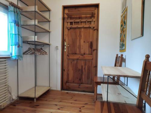 a room with a wooden door and a table at Domek Drewniany in Nowa Wola