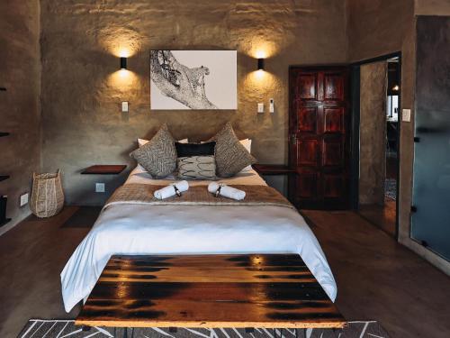 a bedroom with a large bed in a room at Rhino's Rest Luxury Villa in Hoedspruit