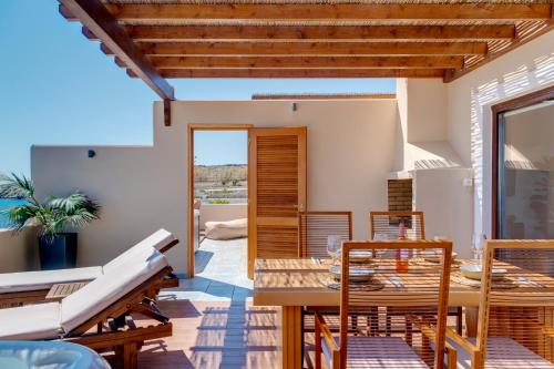 a dining room with a table and chairs at Lalari Beach Suites in Vari