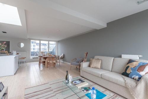 a living room with a couch and a table at Sweet Inn - Waterloo in Brussels