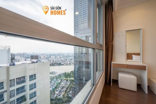 an apartment balcony with a view of the city at Vinhomes CenTral Park Saigon in Ho Chi Minh City