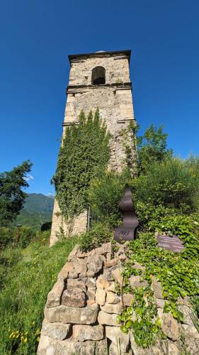 an old tower on top of a grassy hill at B&B Fiume in Morino