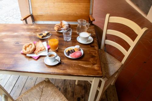 a table with breakfast foods and drinks on it at Locanda Dolcevita in Dozza