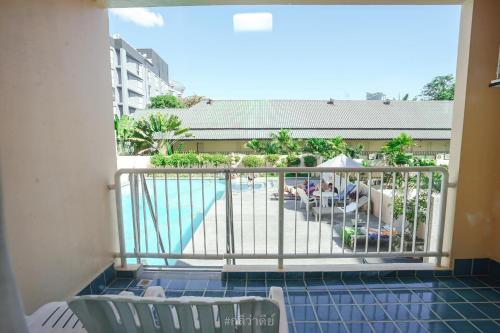 a balcony with a view of a swimming pool at Best Bella Pattaya in North Pattaya