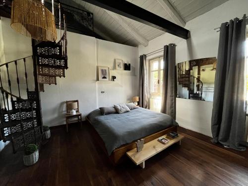 a bedroom with a bed and a staircase in it at Cascina gnocca VIVERONE avventura in Viverone