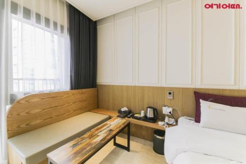 a hotel room with a bed and a desk in it at Chungjangro Ilbeonji Boutique Hotel in Gwangju