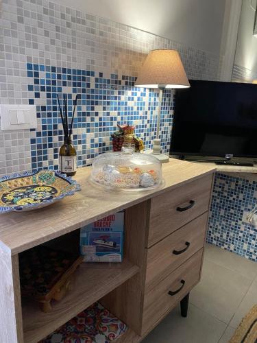a kitchen counter with a table with plates of food on it at La Dimora del Viaggiatore Luxury Apartments in Mazara del Vallo