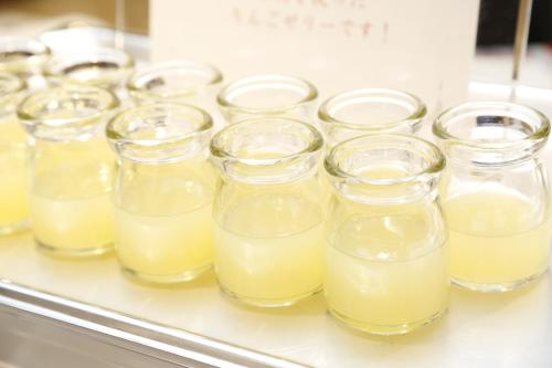 a row of glasses filled with yellow liquid at Dormy Inn Hon-Hachinohe in Hachinohe