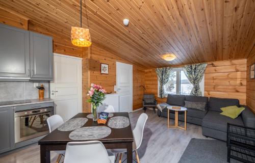 a living room with a couch and a table at Arctic Nature Lodge in Inari