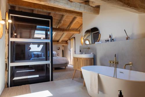 ein Badezimmer mit Badewanne und ein Schlafzimmer in der Unterkunft U MULINU CASANELLI in Fozzano
