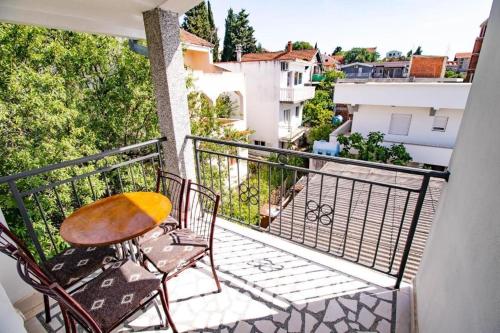 a balcony with a table and chairs on a balcony at Vila Vojka in Bar