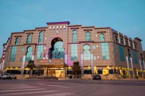 a large building with cars parked in front of it at Innyar Hotel - فندق انيار in Riyadh