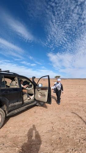 a group of people in a vehicle in the desert at Mhamid Tours berbère in Mhamid