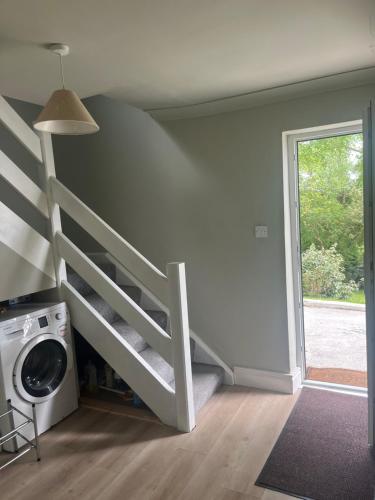 a room with a bunk bed and a washing machine at Lough Corrib Lodge - with private access to lake in Galway