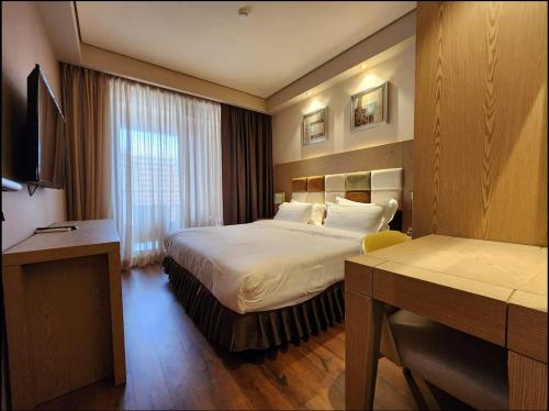 a hotel room with two beds and a desk at Dreamland Oasis luxury apartment in Chakvi