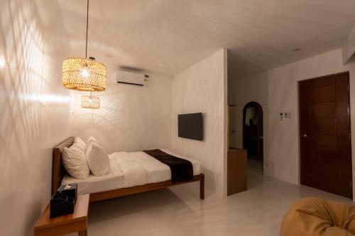a bedroom with a bed and a chandelier at Serene Oasis Resort - Oslob Cebu Philippines in Oslob