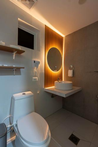 a bathroom with a white toilet and a sink at Serene Oasis Resort - Oslob Cebu Philippines in Oslob