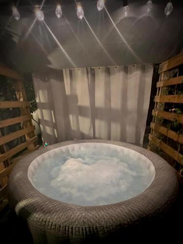 a large tub in a room with a window at La Perla in Monza