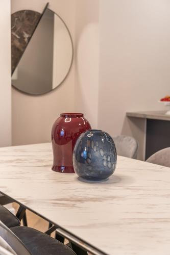 a table with a vase sitting on top of it at Luxury 3BDR In The Heart Of Jerusalem in Jerusalem