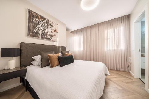 a bedroom with a large white bed with pillows at Luxury 3BDR In The Heart Of Jerusalem in Jerusalem