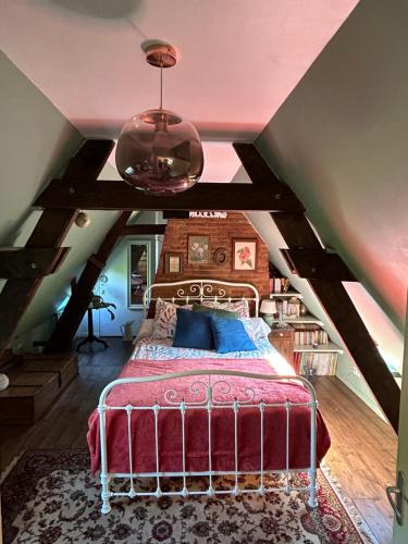 a bedroom with a bed in a attic at Chambre cosy 