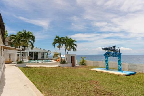 a statue of a bird on a stand in front of a house at Serene Oasis Resort - Oslob Cebu Philippines in Oslob