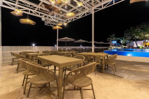 a row of tables and chairs with umbrellas at night at Serene Oasis Resort - Oslob Cebu Philippines in Oslob