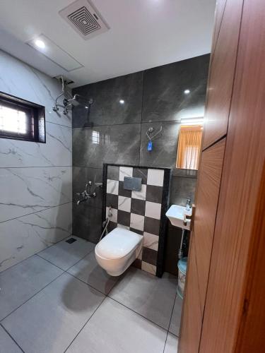 a bathroom with a toilet and a sink at Royale Revera in Cochin