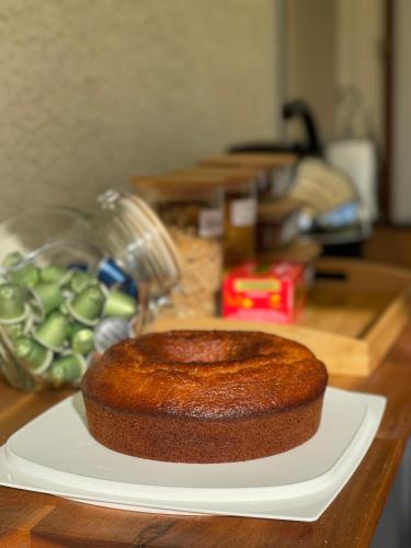 a cake sitting on a white plate on a table at Chambre d'hôte chez Roberto et Hervé in Puilboreau