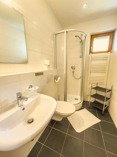 a bathroom with a sink and a toilet and a shower at Modern Mountain Apart 5 - an der Skipiste in Rauris