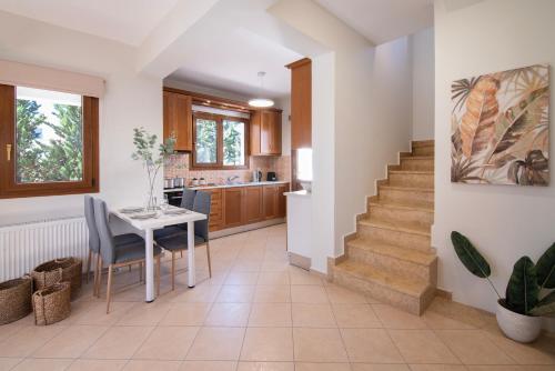 a kitchen and living room with a table and stairs at Katrin Aegina in Egina