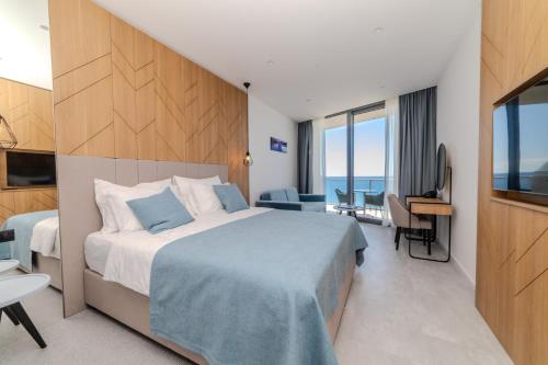 um quarto de hotel com uma cama e uma televisão em Hotel & Spa Ponta Plaza em Budva