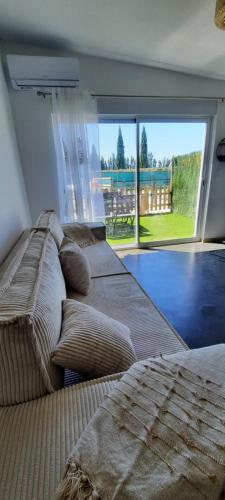 un salon avec deux lits et une grande fenêtre dans l'établissement Appart'Estel 2 pers en campagne avec terrasse et accès piscine, à Tarascon