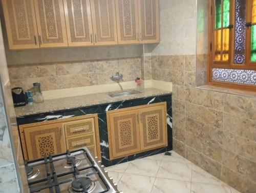 a kitchen with a sink and a counter at Maison Moussaoui in Meknès